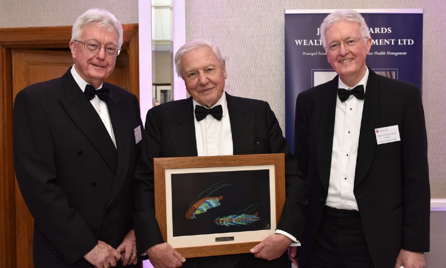 Sir David Attenborough with a framed photo of the lobster crustacean that was named after him in 2017