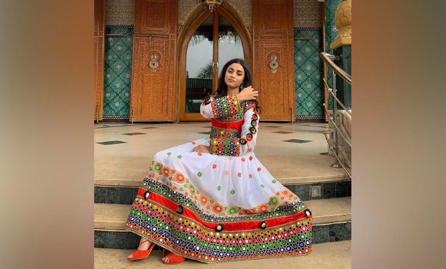 Another Afghan woman who has posed and posted a photo of herself in traditional vibrant Afghan clothing to support women's rights against the Taliban