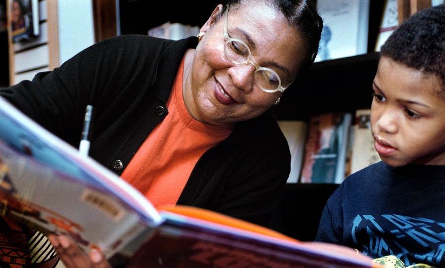 bell hooks, author of Ain't I a Woman?, signs a copy of her picture book Homemade Love for a child. (Photo: The Washington Post/Getty Images)