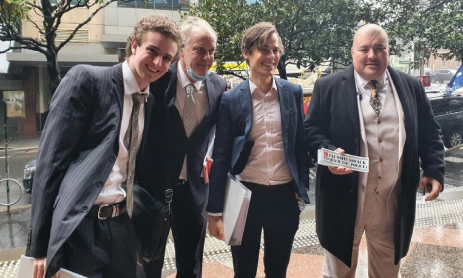 Jordan Shanks and lawyers after defamation case dropped. Source- 7 News
