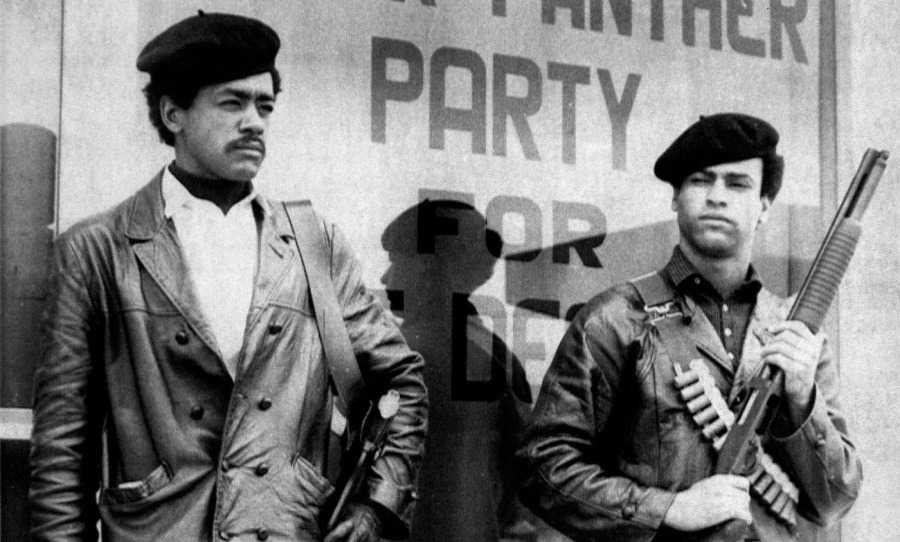 Bobby Seale (left) and Huey P. Newton (right) stand outside the first Black Panther Party Headquarters, in Oakland, CA. Photo: Black Panther Party. 