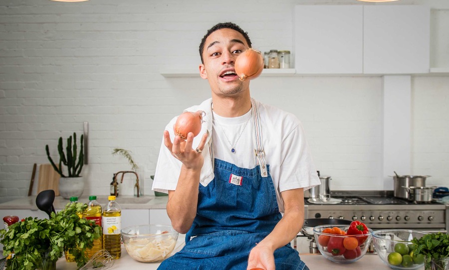 Loyle Carner cooking in a kitchen