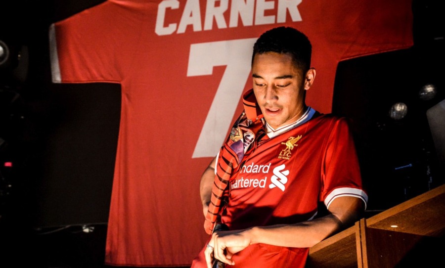 Loyle Carner wearing Liverpool FC jersey