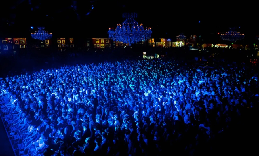 A sold-out crowd bathed in blue light at Mk.gee’s Gather No Moss tour opener at the Fillmore Auditorium in Denver.