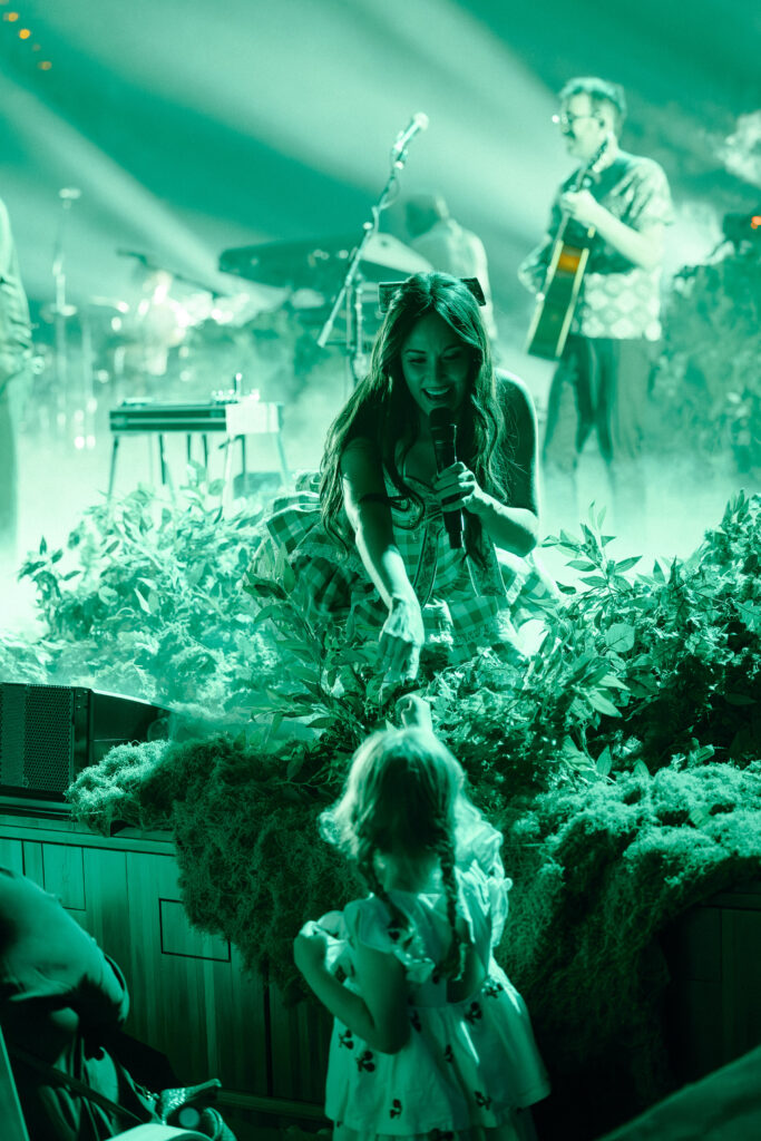 kacey helping young girl on stage